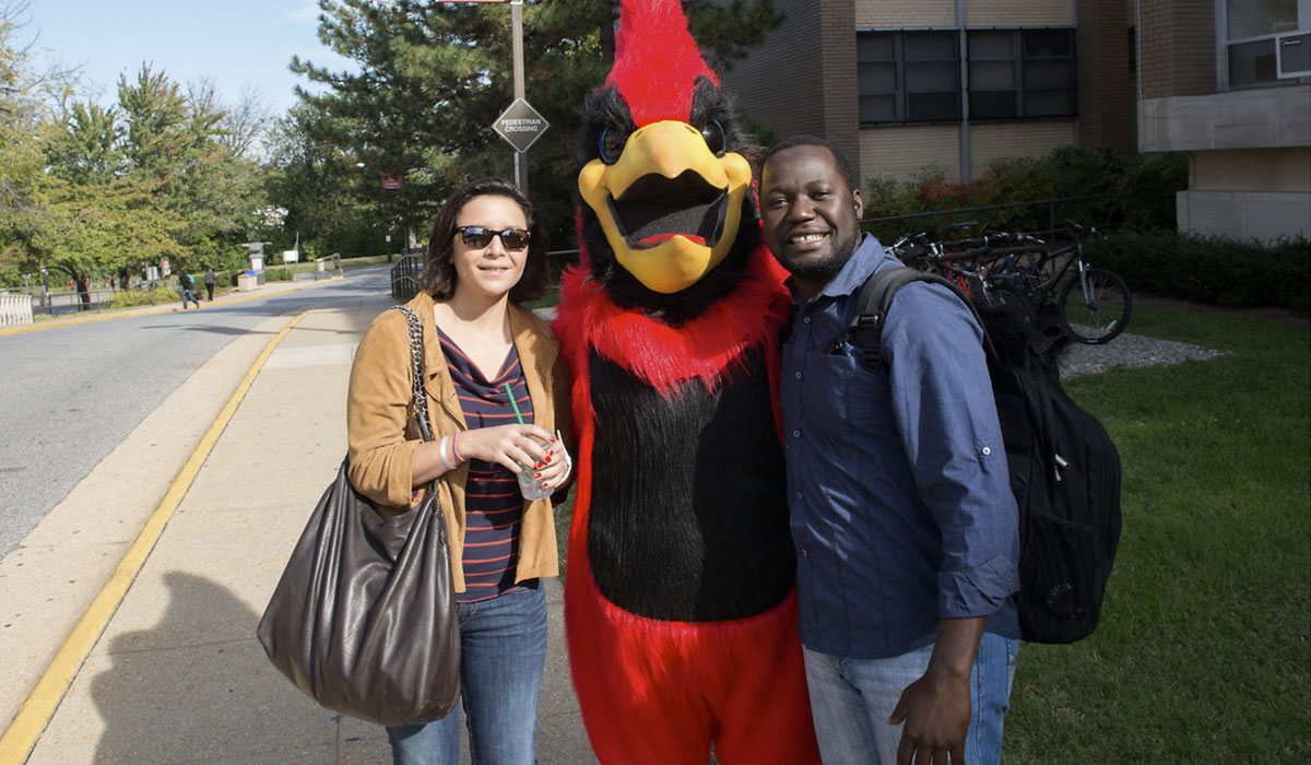 Cardinal Mascot with students